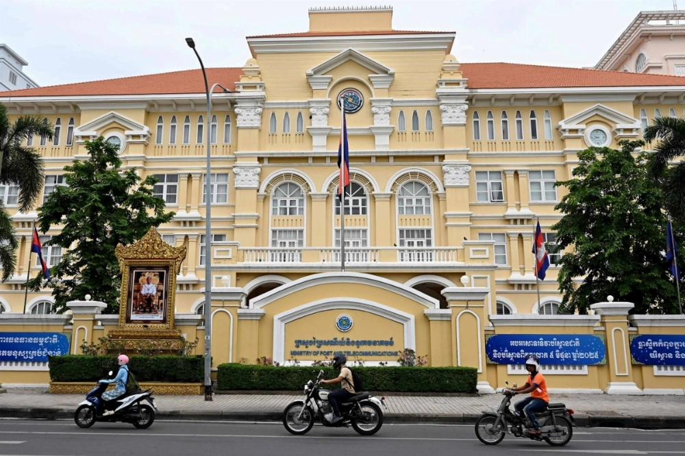 Motorists ride along a street in front of Cambodia's Ministry of Post and Telecommunications in Phnom Penh on Friday. Cambodia ordered its troops to stay on "full alert" June 13 in its ongoing border spat with Thailand, as it ordered television stations and cinemas to stop showing Thai dramas. Motorists ride along a street in front of Cambodia's Ministry of Post and Telecommunications in Phnom Penh on Friday. Cambodia ordered its troops to stay on "full alert" June 13 in its ongoing border spat with Thailand, as it ordered television stations and cinemas to stop showing Thai dramas.