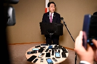 Ryosei Akazawa, Japan's economic revitalization minster, speaks to members of the media in Washington on Friday. | BLOOMBERG
