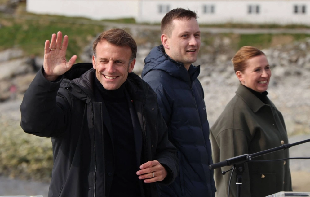 French President Emmanuel Macron (left) gestures next to Greenland Prime Minister Jens-Frederik Nielsen (center) and Danish Prime Minister Mette Frederiksen at the end of a joint press conference in Nuuk, Greenland, on Sunday. French President Emmanuel Macron (left) gestures next to Greenland Prime Minister Jens-Frederik Nielsen (center) and Danish Prime Minister Mette Frederiksen at the end of a joint press conference in Nuuk, Greenland, on Sunday.