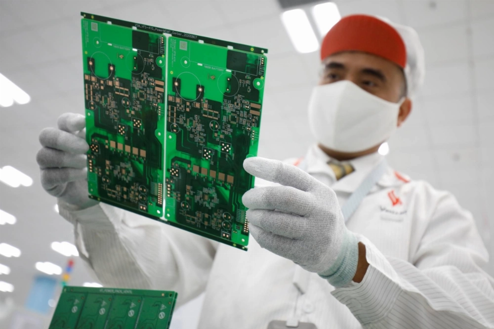 A man checks a mainboard at an assembly line to produce ventilators at a Vsmart factory outside Hanoi in 2020.  A man checks a mainboard at an assembly line to produce ventilators at a Vsmart factory outside Hanoi in 2020.