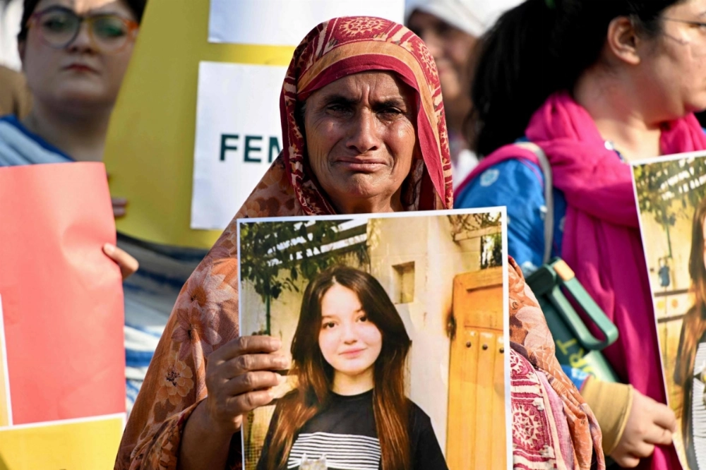 A woman weeps as she holds a poster of TikTok star Sana Yousaf during a protest to condemn violence against women, after Yousaf was killed for rejecting a man's proposal in Islamabad. A woman weeps as she holds a poster of TikTok star Sana Yousaf during a protest to condemn violence against women, after Yousaf was killed for rejecting a man's proposal in Islamabad.