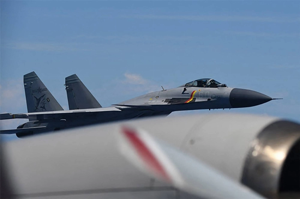A J-15 fighter jet from the Chinese aircraft carrier Shandong makes an unusual approach to a Maritime Self-Defense Force P-3C patrol aircraft that was conducting surveillance above the Pacific Ocean on June 8. A J-15 fighter jet from the Chinese aircraft carrier Shandong makes an unusual approach to a Maritime Self-Defense Force P-3C patrol aircraft that was conducting surveillance above the Pacific Ocean on June 8.
