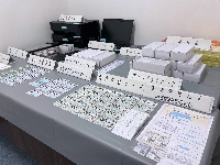 Forged My Number cards and other ID cards seized by police are shown at a police station in Tokyo in December 2023. | Jiji
