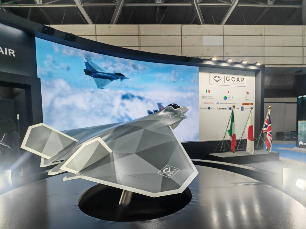 A model of a next-generation fighter jet that is being developed by Japan, Italy and the U.K. is displayed at the DSEI Japan defense exhibition in Chiba in May.  A model of a next-generation fighter jet that is being developed by Japan, Italy and the U.K. is displayed at the DSEI Japan defense exhibition in Chiba in May.