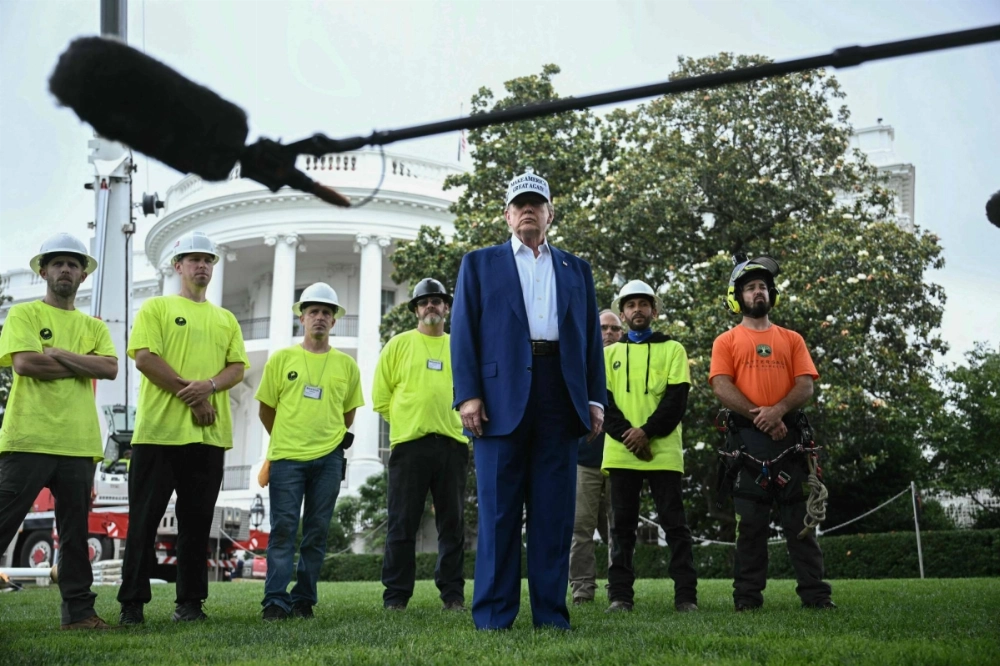 U.S. President Donald Trump speaks to the press as workers install a large flag pole on the South Lawn of the White House in Washington on Thursday. U.S. President Donald Trump speaks to the press as workers install a large flag pole on the South Lawn of the White House in Washington on Thursday.