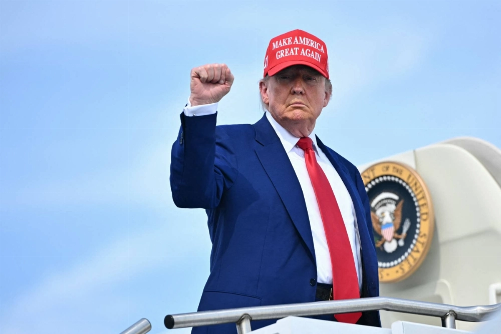 U.S. President Donald Trump pumps his fist as boards Air Force One at Morristown Municipal Airport in Morristown, New Jersey, on Saturday. U.S. President Donald Trump pumps his fist as boards Air Force One at Morristown Municipal Airport in Morristown, New Jersey, on Saturday.