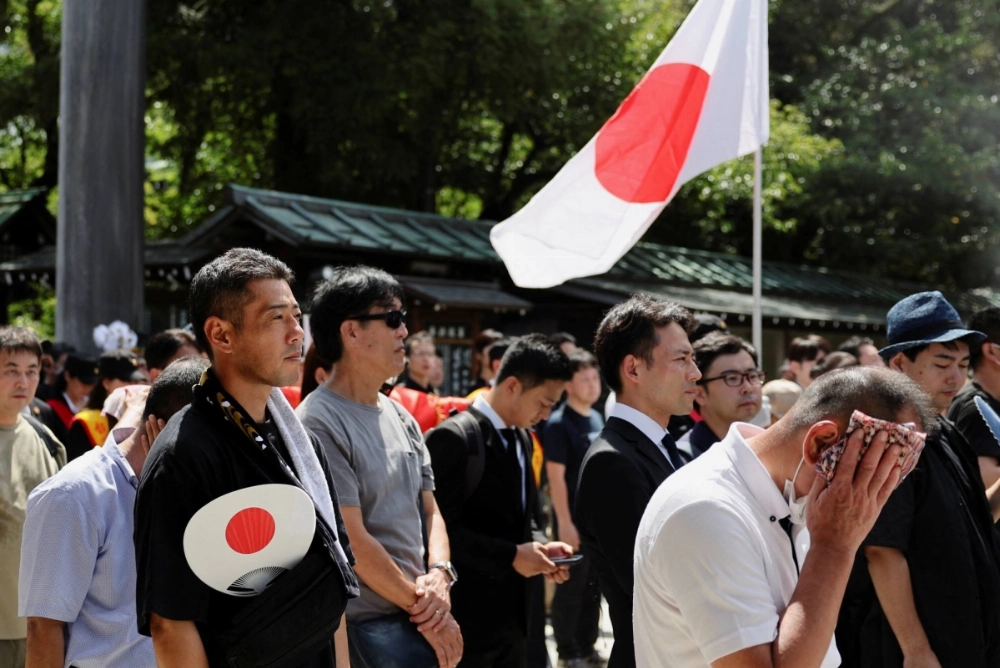 People pray during a visit to Yasukuni Shrine in Tokyo on Aug. 15, the 79th anniversary of Japan's surrender during World War II. People pray during a visit to Yasukuni Shrine in Tokyo on Aug. 15, the 79th anniversary of Japan's surrender during World War II.