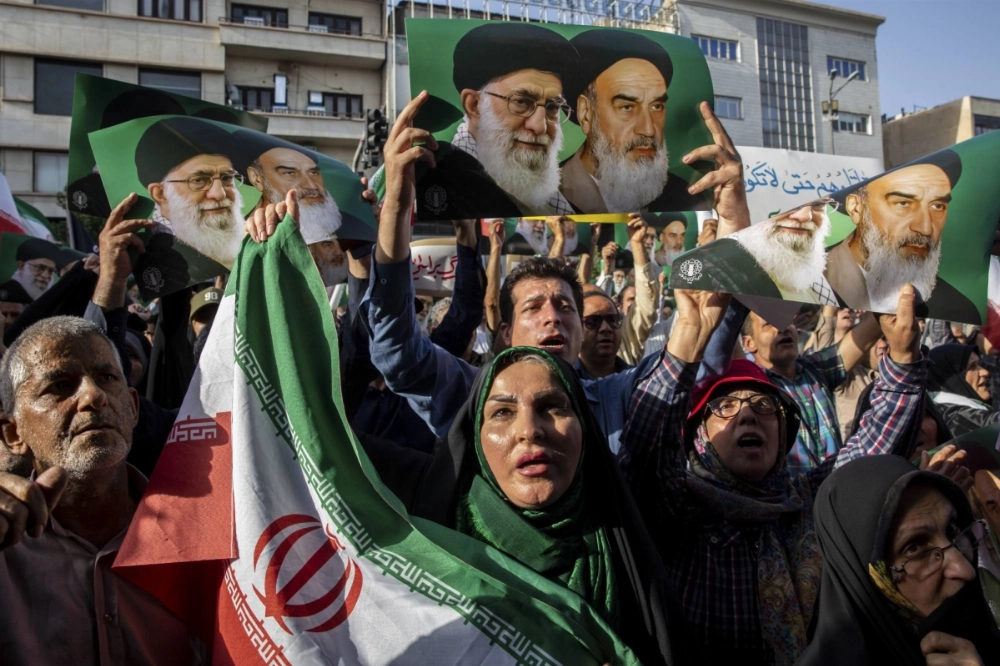 People attend a protest following U.S. attacks on Iranian nuclear sites, in Tehran on Sunday. People attend a protest following U.S. attacks on Iranian nuclear sites, in Tehran on Sunday.
