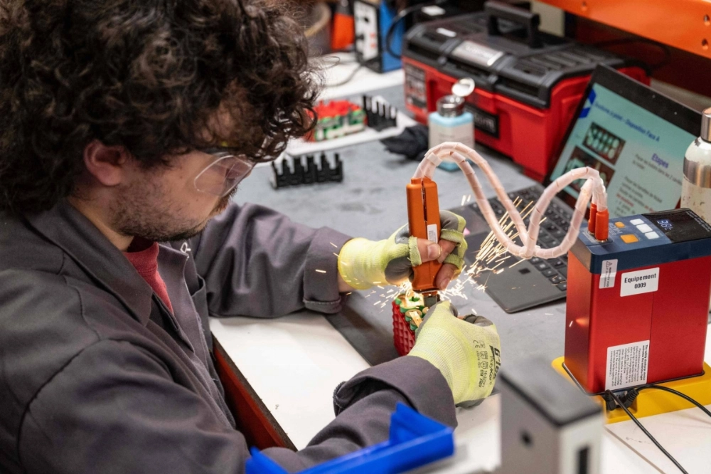 An employee welds lithium batteries in Verrieres-en-Anjou, western France, on June 10.  An employee welds lithium batteries in Verrieres-en-Anjou, western France, on June 10.