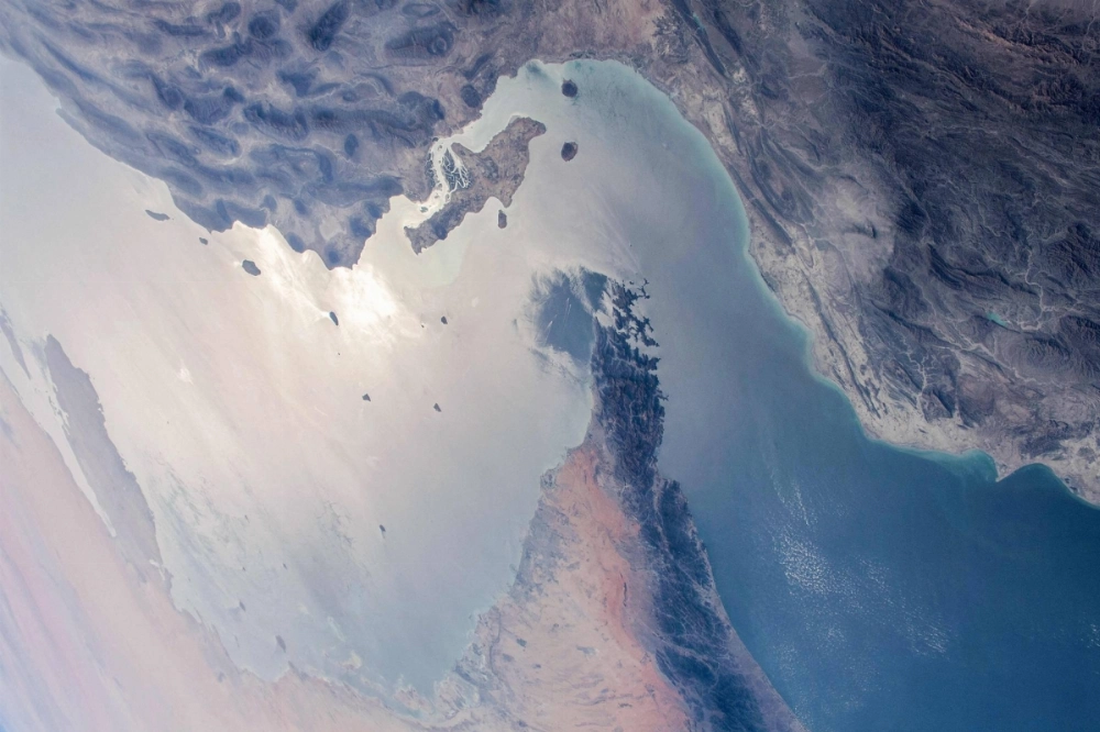 The Strait of Hormuz separating Iran (top) from the United Arab Emirates and Oman (bottom) as seen from the International Space Station in 2021. More than half of the oil imported by East Asia passes through the Strait, experts estimate. The Strait of Hormuz separating Iran (top) from the United Arab Emirates and Oman (bottom) as seen from the International Space Station in 2021. More than half of the oil imported by East Asia passes through the Strait, experts estimate.