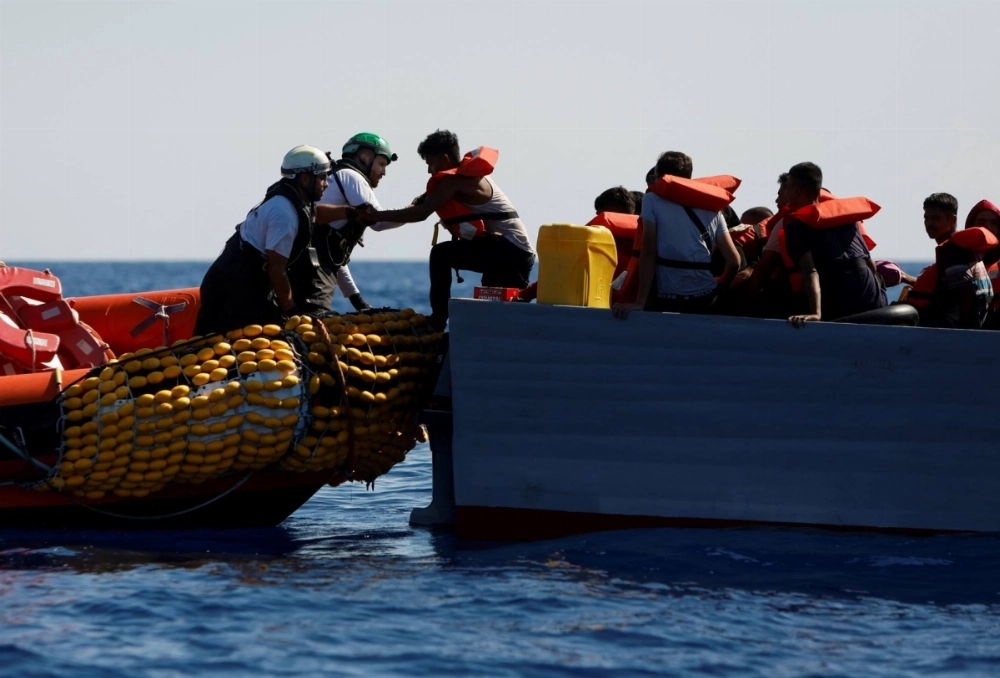 Migrants are rescued from a wooden boat by Doctors Without Borders in international waters off the coast of Tunisia in the central Mediterranean Sea in July 2024. Migrants are rescued from a wooden boat by Doctors Without Borders in international waters off the coast of Tunisia in the central Mediterranean Sea in July 2024.
