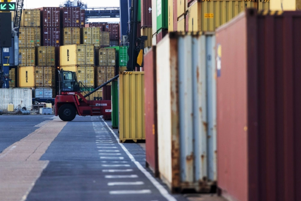 A worker moves a shipping container at Felixstowe port in Felixstowe, U.K. A worker moves a shipping container at Felixstowe port in Felixstowe, U.K.
