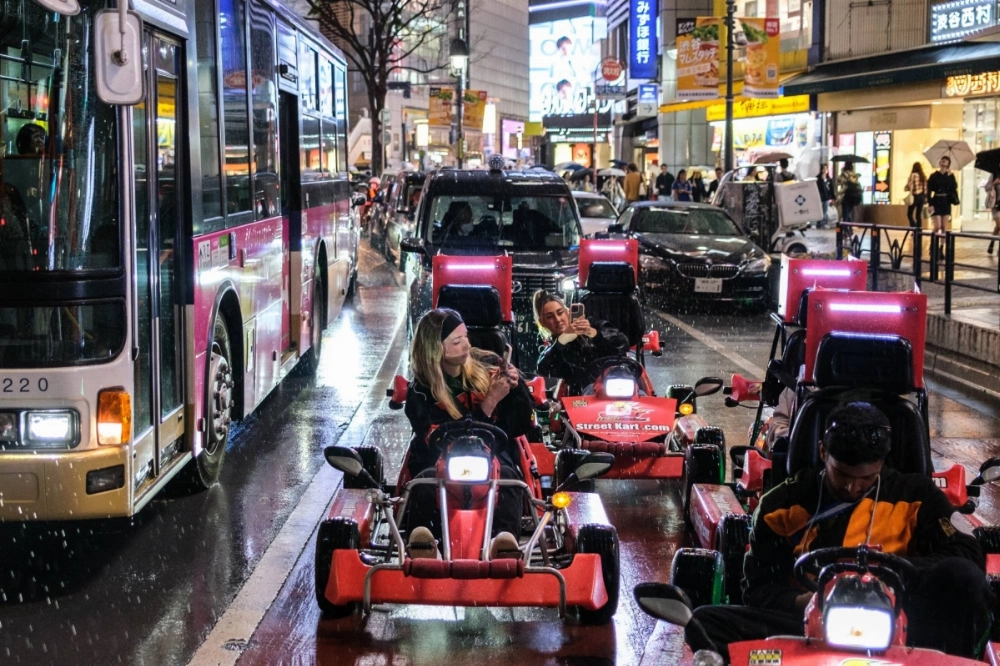A group of tourists drive go-karts in Tokyo's Shibuya Ward on April 18, 2024. The ward will introduce new regulations on go-kart rental operators starting July 1. A group of tourists drive go-karts in Tokyo's Shibuya Ward on April 18, 2024. The ward will introduce new regulations on go-kart rental operators starting July 1.