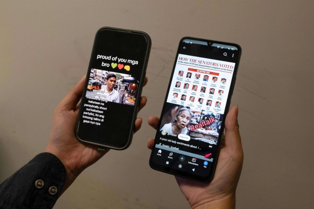Two mobile phones show different viral AI-generated videos of people voicing their opinions on the impeachment of Philippine Vice President Sara Duterte.  Two mobile phones show different viral AI-generated videos of people voicing their opinions on the impeachment of Philippine Vice President Sara Duterte.