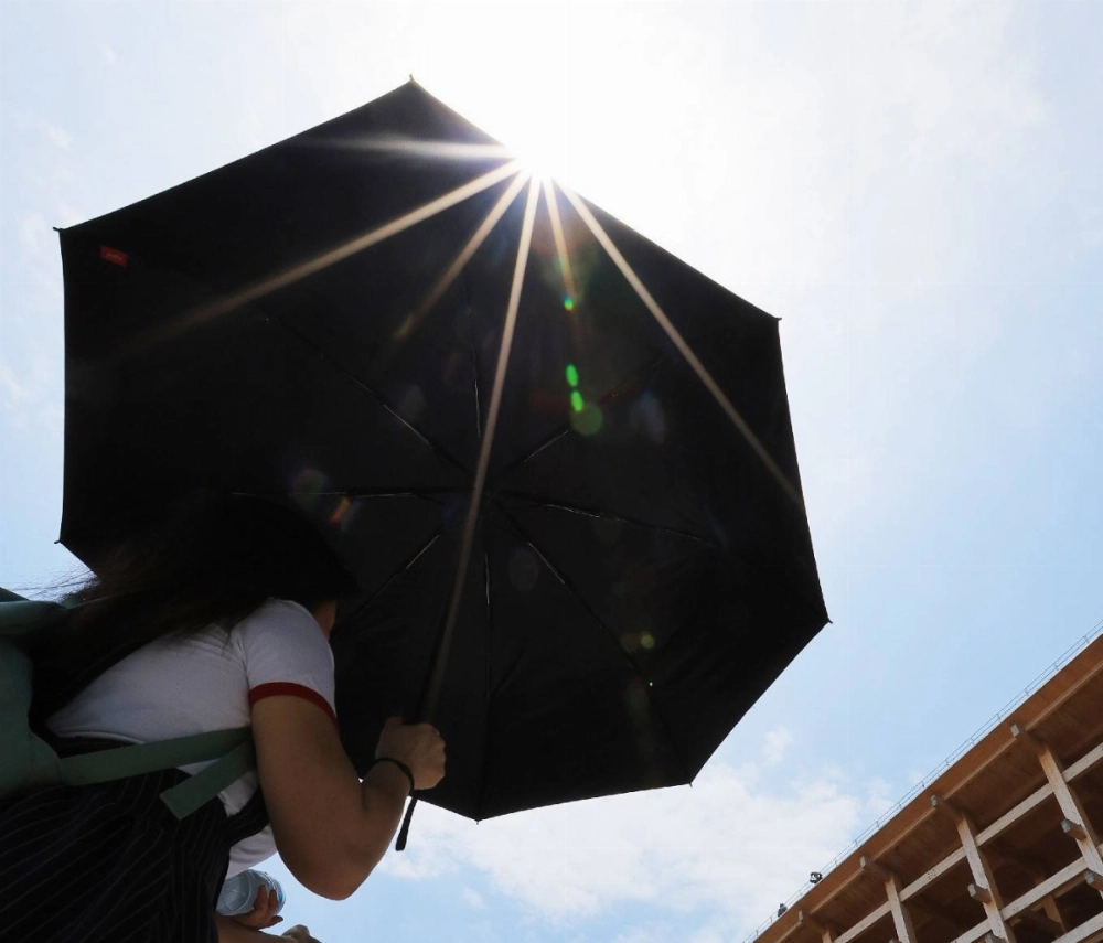 Visitors to the Osaka Expo walk under the sun in the city of Osaka on Friday as the rainy season ended at the earliest date on record in the country's western regions that day. Visitors to the Osaka Expo walk under the sun in the city of Osaka on Friday as the rainy season ended at the earliest date on record in the country's western regions that day.