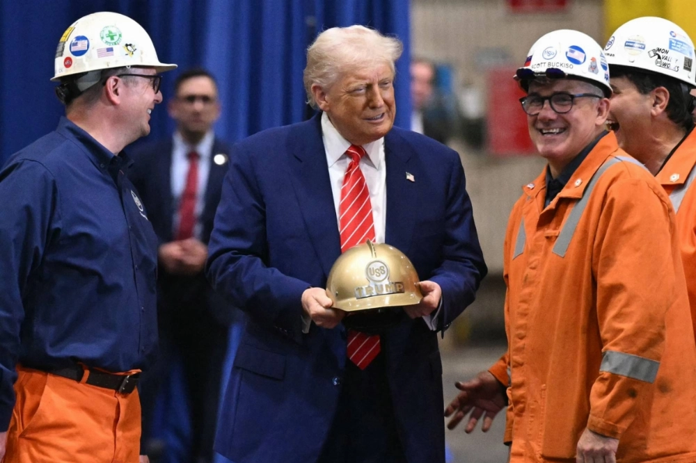 U.S. President Donald Trump receives a gold helmet with his name on it during a visit to U.S. Steel in West Mifflin, Pennsylvania. U.S. President Donald Trump receives a gold helmet with his name on it during a visit to U.S. Steel in West Mifflin, Pennsylvania.