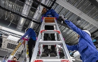 Trainees practice installing an air conditioner at a Daikin facility in Phnom Penh. Daikin has vowed to reach net-zero emissions by 2050 as it seeks to rollout more efficient products.  | ANTON L. Delgado