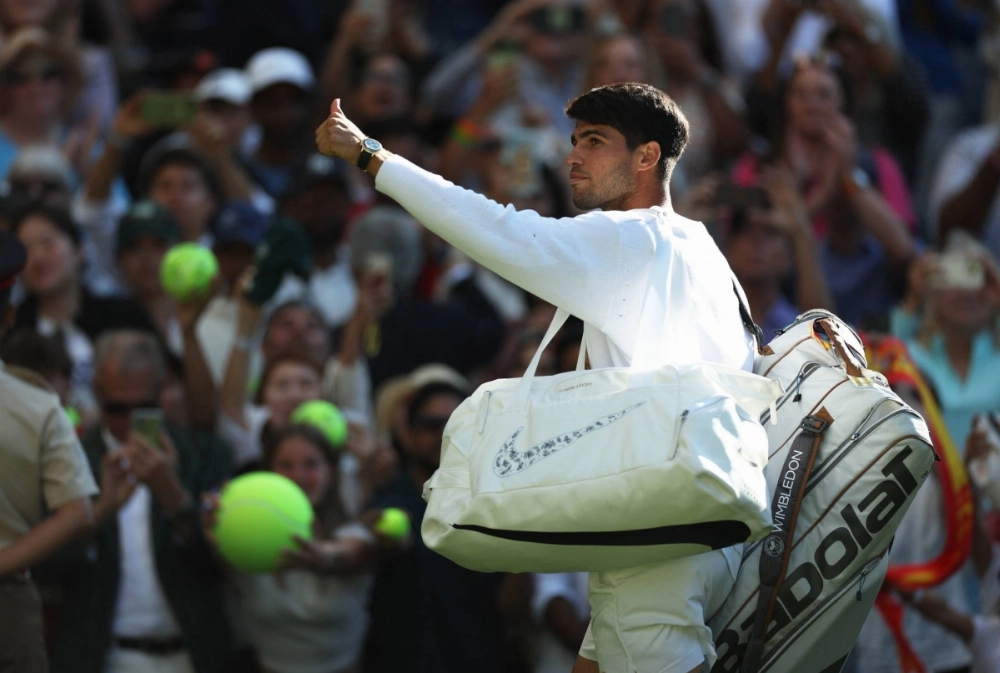 Carlos Alcaraz celebrates after his victory over Oliver Tarvet at Wimbledon on Wednesday. Carlos Alcaraz celebrates after his victory over Oliver Tarvet at Wimbledon on Wednesday.