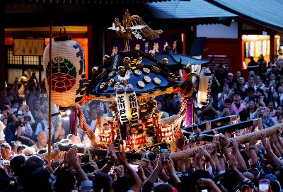People carry a portable shrine at Sensoji temple during the Sanja Festival in May. The festival is one of the three largest in Tokyo. People carry a portable shrine at Sensoji temple during the Sanja Festival in May. The festival is one of the three largest in Tokyo.