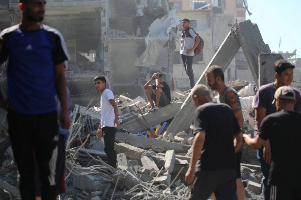 Palestinians inspect the damage after an Israeli strike in the Al-Bureij camp in the central Gaza Strip on Friday. Palestinians inspect the damage after an Israeli strike in the Al-Bureij camp in the central Gaza Strip on Friday.