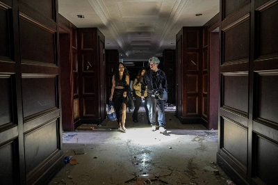 Xu Pengcheng (right), model Mao Yi and Nono walk along a corridor inside an abandoned hotel in Shanghai on May 24. Xu Pengcheng (right), model Mao Yi and Nono walk along a corridor inside an abandoned hotel in Shanghai on May 24.