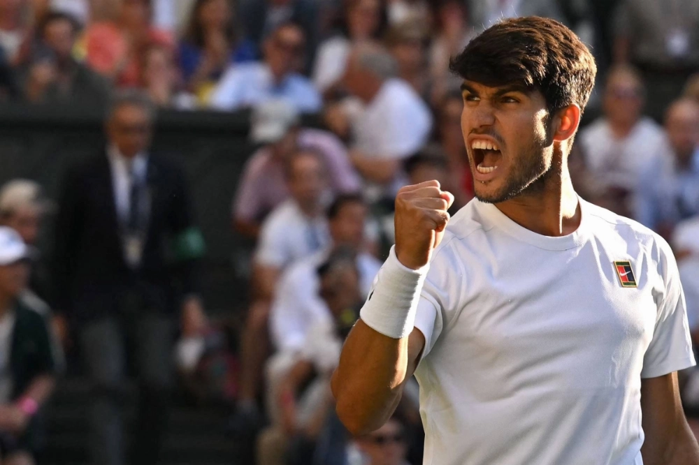 Carlos Alcaraz celebrates after winning his Wimbledon quarterfinal match against Cameron Norrie on Tuesday in London.  Carlos Alcaraz celebrates after winning his Wimbledon quarterfinal match against Cameron Norrie on Tuesday in London.