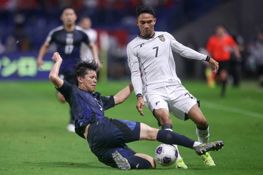 Japan defender Kota Takai (left) challenges Indonesia's Marselino Ferdinan during a World Cup qualifying match in Suita, Osaka Prefecture, on June 10.  Japan defender Kota Takai (left) challenges Indonesia's Marselino Ferdinan during a World Cup qualifying match in Suita, Osaka Prefecture, on June 10.
