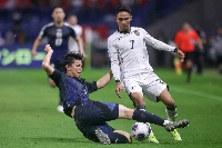 Japan defender Kota Takai (left) challenges Indonesia's Marselino Ferdinan during a World Cup qualifying match in Suita, Osaka Prefecture, on June 10.  | AFP-JIJI