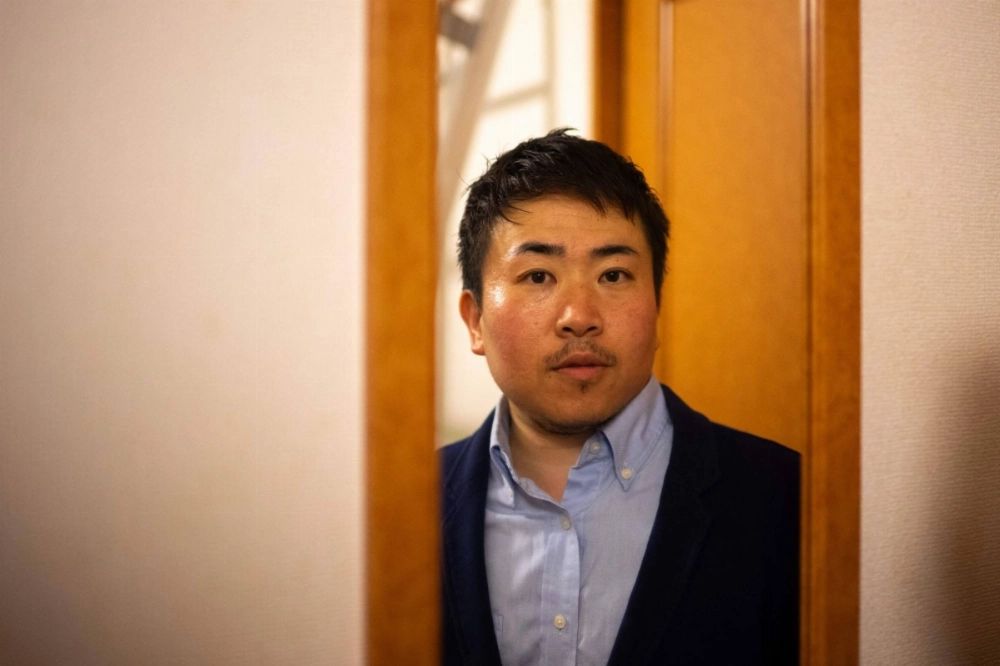 Tomoya Asanuma, a man who endured almost four months of detention for charges he was ultimately acquitted of in January, poses for a picture at his apartment in Tokyo in May. Tomoya Asanuma, a man who endured almost four months of detention for charges he was ultimately acquitted of in January, poses for a picture at his apartment in Tokyo in May.