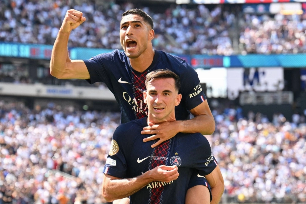 Paris Saint-Germain midfielder Fabian Ruiz (bottom) celebrates with defender Achraf Hakimi after Ruiz scored PSG's third goal of its Club World Cup semifinal win over Real Madrid on Wednesday in East Rutherford, New Jersey.  Paris Saint-Germain midfielder Fabian Ruiz (bottom) celebrates with defender Achraf Hakimi after Ruiz scored PSG's third goal of its Club World Cup semifinal win over Real Madrid on Wednesday in East Rutherford, New Jersey.