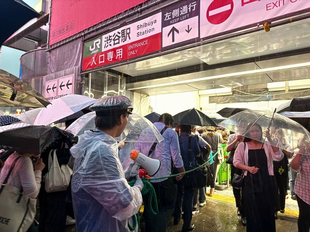 People line up at Shibuya Station in Tokyo as they try to avoid the heavy rain on Thursday. People line up at Shibuya Station in Tokyo as they try to avoid the heavy rain on Thursday.