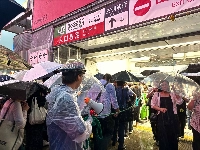 People line up at Shibuya Station in Tokyo as they try to avoid the heavy rain on Thursday. | Nico Phillips