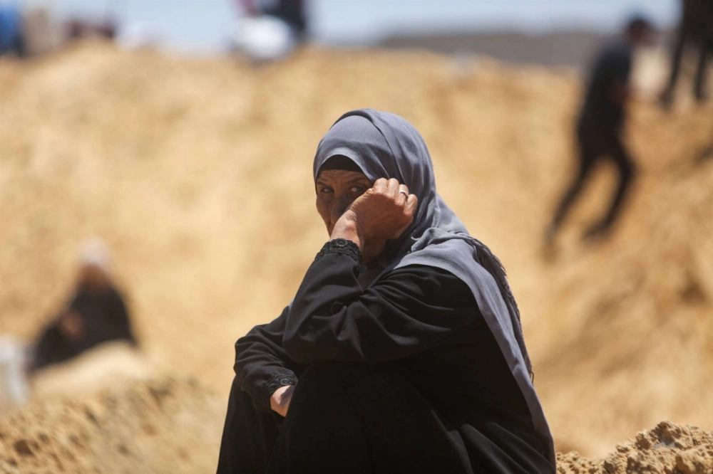 A woman looks on as Palestinians inspect destroyed tents at a makeshift displacement camp following a reported incursion a day earlier by Israeli tanks in the area in Khan Younis, in the southern Gaza Strip, on Friday. A woman looks on as Palestinians inspect destroyed tents at a makeshift displacement camp following a reported incursion a day earlier by Israeli tanks in the area in Khan Younis, in the southern Gaza Strip, on Friday.