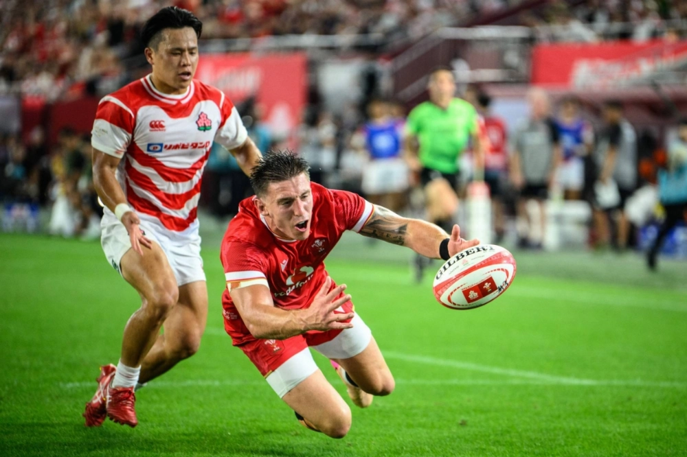Wales' wing Josh Adams tries to catch the ball during a match against Japan in Kobe on Saturday.  Wales' wing Josh Adams tries to catch the ball during a match against Japan in Kobe on Saturday.