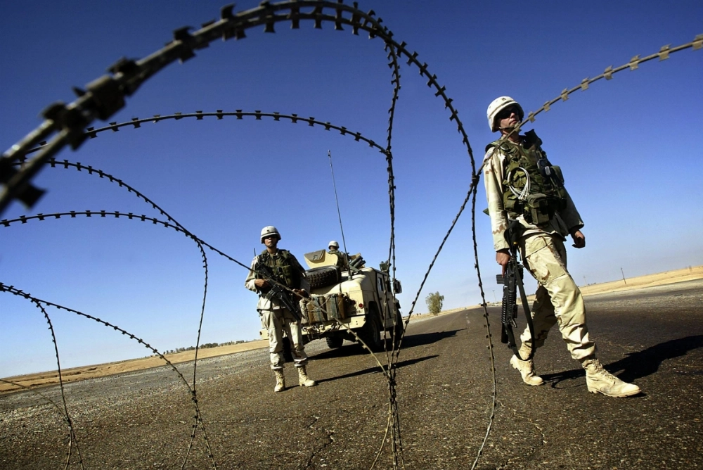 U.S. soldiers man a checkpoint on a road outside Tikrit, Iraq, in November 2003. Airstrikes alone won’t truly eliminate Iran’s nuclear program — only a costly ground invasion like the one that took down Saddam Hussein could do that. U.S. soldiers man a checkpoint on a road outside Tikrit, Iraq, in November 2003. Airstrikes alone won’t truly eliminate Iran’s nuclear program — only a costly ground invasion like the one that took down Saddam Hussein could do that.
