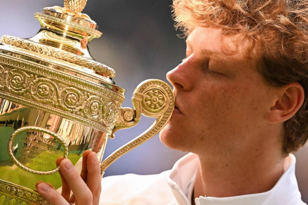 Jannik Sinner kisses the winner's trophy as he poses for pictures following his victory against Carlos Alcaraz at the end of their men's singles final tennis match at the 2025 Wimbledon Championships in Wimbledon, London, on Sunday. Jannik Sinner kisses the winner's trophy as he poses for pictures following his victory against Carlos Alcaraz at the end of their men's singles final tennis match at the 2025 Wimbledon Championships in Wimbledon, London, on Sunday.