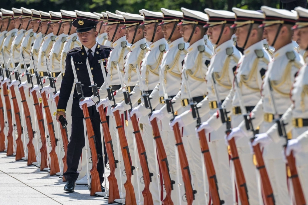 A senior member of a Self-Defense Forces honor guard inspects a formation before the arrival of Prime Minister Shigeru Ishiba for a visit to the Defense Ministry in Tokyo on June 30. A senior member of a Self-Defense Forces honor guard inspects a formation before the arrival of Prime Minister Shigeru Ishiba for a visit to the Defense Ministry in Tokyo on June 30.