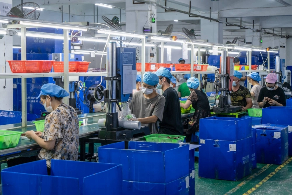 Workers on the production line of a toy factory in Shenzhen, China Workers on the production line of a toy factory in Shenzhen, China