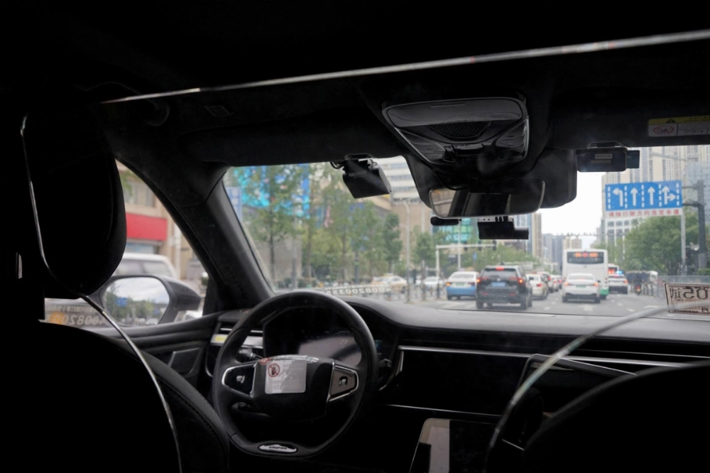 A driverless car by Apollo Go, Baidu's robotaxi service, drives on a road in Wuhan, Hubei province, China, on July 19, 2024.  A driverless car by Apollo Go, Baidu's robotaxi service, drives on a road in Wuhan, Hubei province, China, on July 19, 2024.