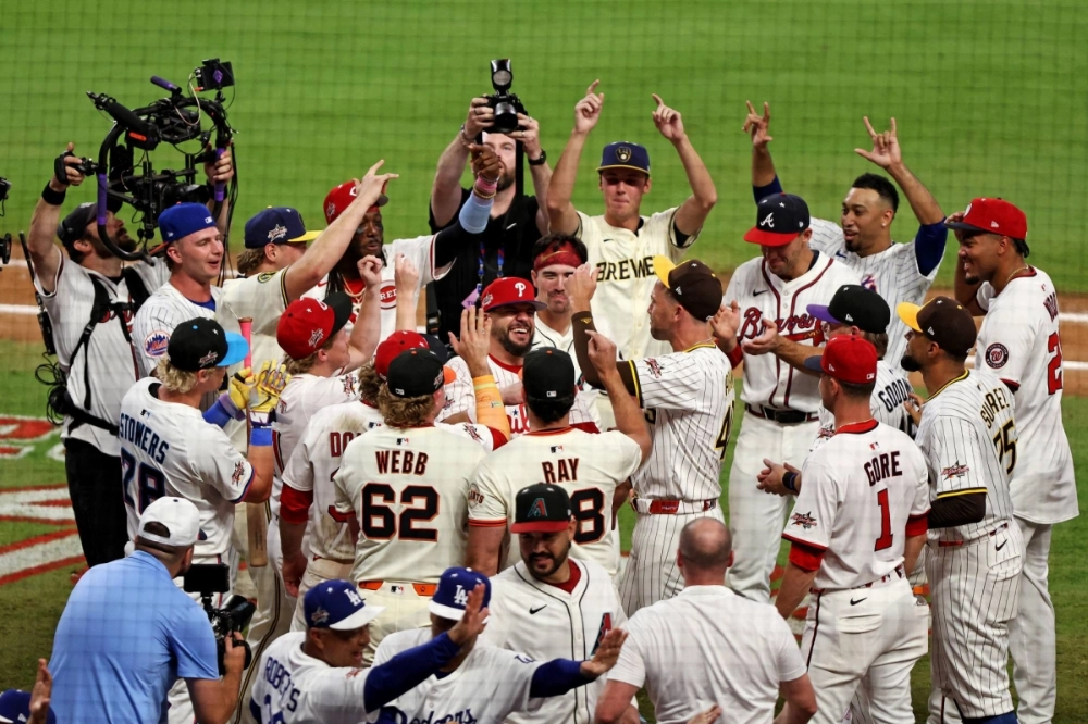 Kyle Schwarber of the Philadelphia Phillies celebrates with his teammates after the National League won a swing-off tiebreaker over the American League on Tuesday in the MLB All-Star Game.  Kyle Schwarber of the Philadelphia Phillies celebrates with his teammates after the National League won a swing-off tiebreaker over the American League on Tuesday in the MLB All-Star Game.