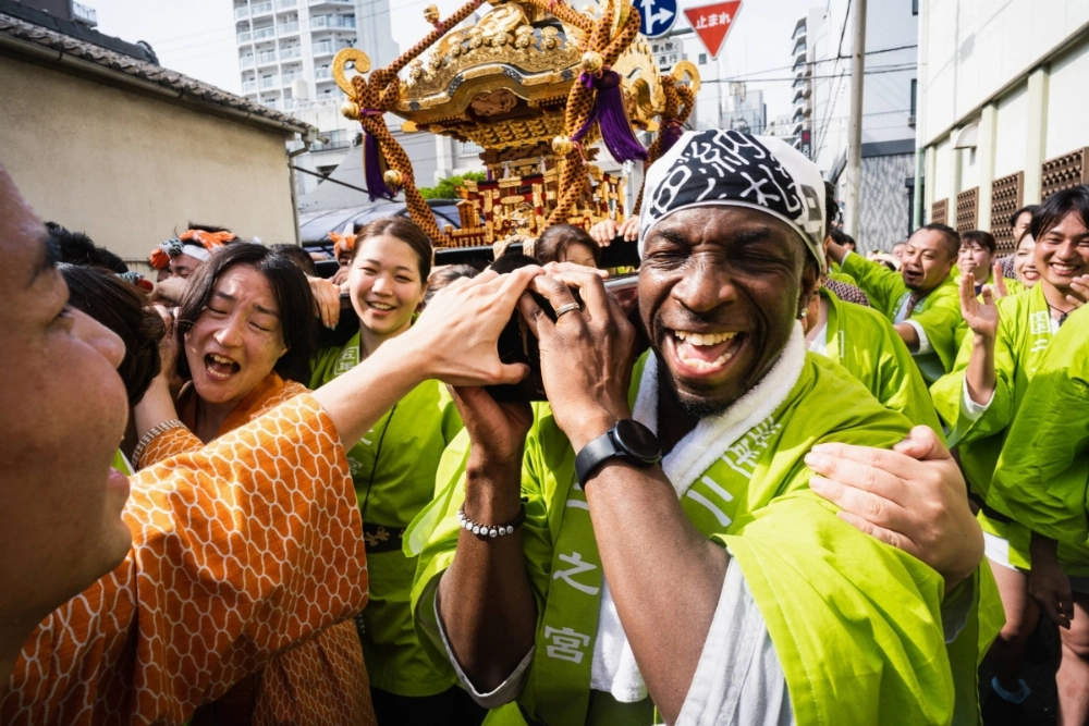 A man takes part in Tokyo’s Sanja Matsuri by helping to carry a "mikoshi" (portable shrine). Many Japanese festivals are open to foreign residents and tourists to participate in.  A man takes part in Tokyo’s Sanja Matsuri by helping to carry a "mikoshi" (portable shrine). Many Japanese festivals are open to foreign residents and tourists to participate in.