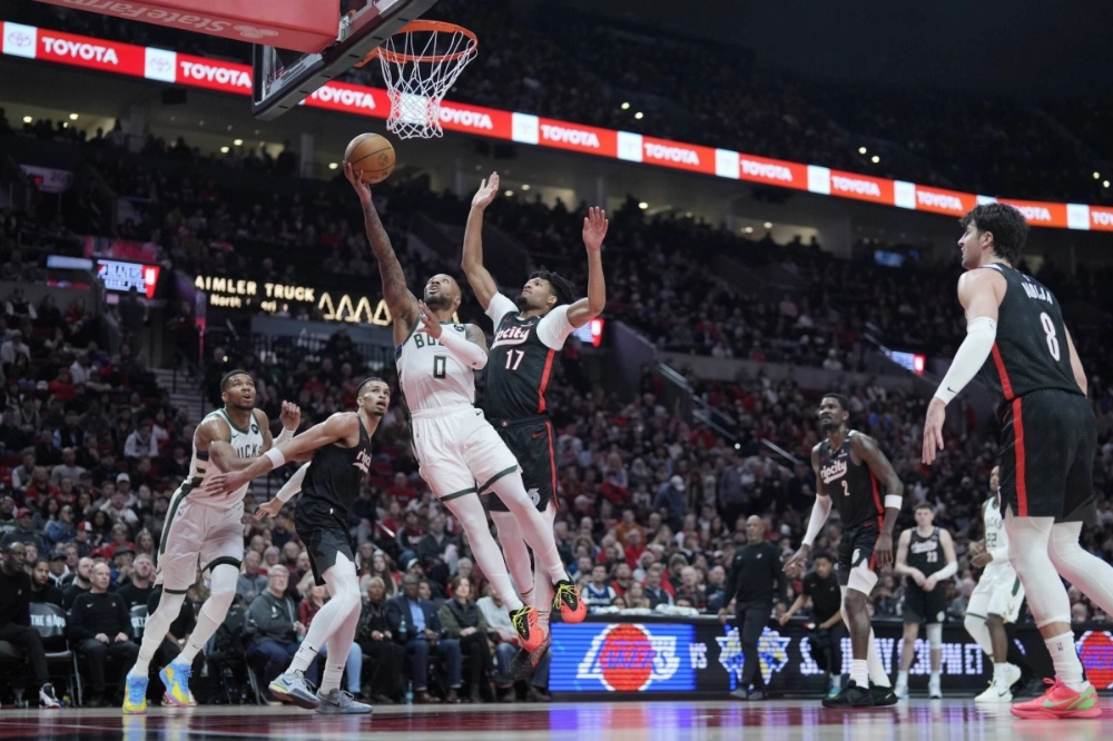 Bucks point guard Damian Lillard shoots the ball past Trail Blazers shooting guard Shaedon Sharpe during the second half at Moda Center in Portland, Oregon on Jan 28. Bucks point guard Damian Lillard shoots the ball past Trail Blazers shooting guard Shaedon Sharpe during the second half at Moda Center in Portland, Oregon on Jan 28.