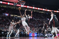 Bucks point guard Damian Lillard shoots the ball past Trail Blazers shooting guard Shaedon Sharpe during the second half at Moda Center in Portland, Oregon on Jan 28. | Imagn Images / via Reuters