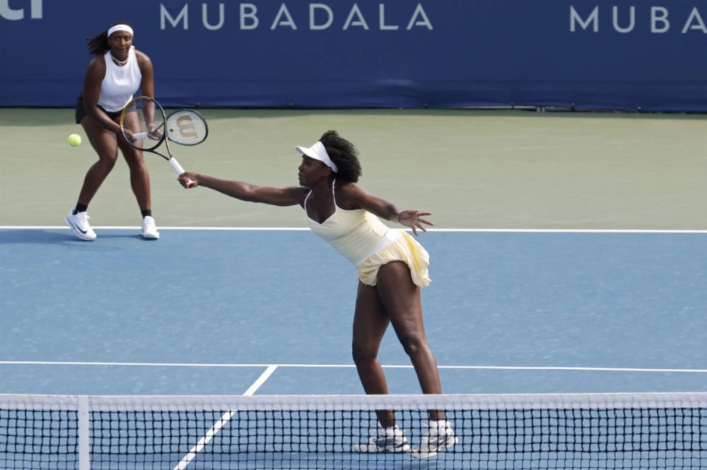 Venus Williams hits a volley as partner Hailey Baptiste looks on in their women's doubles match against Eugenie Bouchard and Clervie Ngounoue on Day 1 of the Mubadala Citi DC Open in Washington on Monday. Venus Williams hits a volley as partner Hailey Baptiste looks on in their women's doubles match against Eugenie Bouchard and Clervie Ngounoue on Day 1 of the Mubadala Citi DC Open in Washington on Monday.