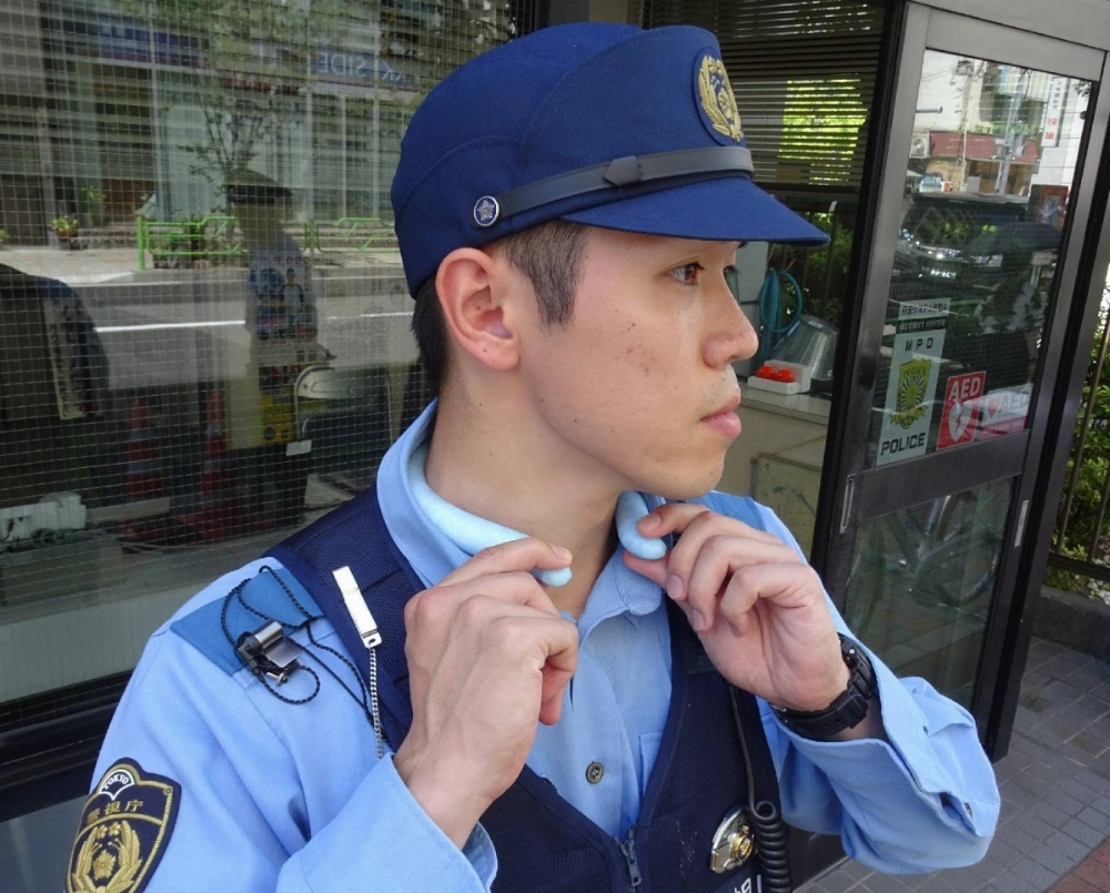 A police officer wears a neck cooler in Tokyo's Chuo Ward on July 10. A police officer wears a neck cooler in Tokyo's Chuo Ward on July 10.