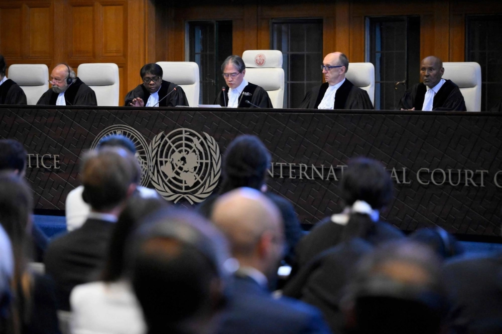 President of the International Court of Justice (ICJ) Yuji Iwasawa (center) and other members issue an advisory opinion on nations' legal obligations to address climate change, at The Hague on Wednesday. President of the International Court of Justice (ICJ) Yuji Iwasawa (center) and other members issue an advisory opinion on nations' legal obligations to address climate change, at The Hague on Wednesday.