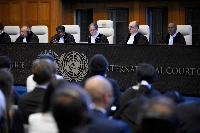 President of the International Court of Justice (ICJ) Yuji Iwasawa (center) and other members issue an advisory opinion on nations' legal obligations to address climate change, at The Hague on Wednesday. | AFP-JIJI