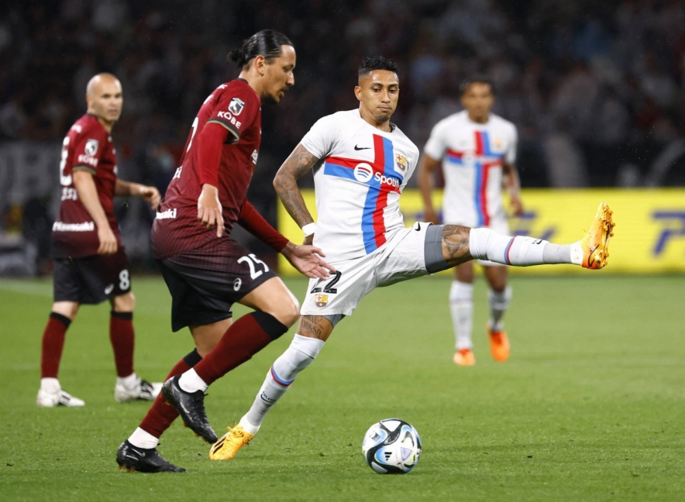 Barcelona's Raphinha (center) battles with Vissel Kobe's Reo Osaki during a friendly in Tokyo on June 6, 2023. Barcelona's Raphinha (center) battles with Vissel Kobe's Reo Osaki during a friendly in Tokyo on June 6, 2023.