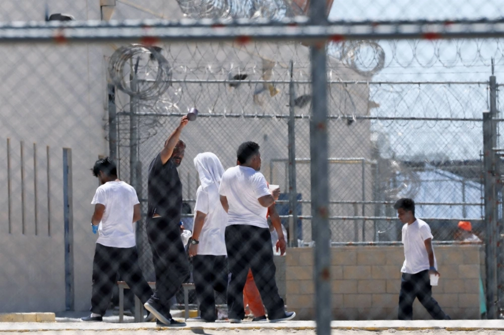 People detained by U.S. immigration forces are seen behind fences at the Desert View Annex at an ICE detention facility in Adelanto, California, on July 10. People detained by U.S. immigration forces are seen behind fences at the Desert View Annex at an ICE detention facility in Adelanto, California, on July 10.