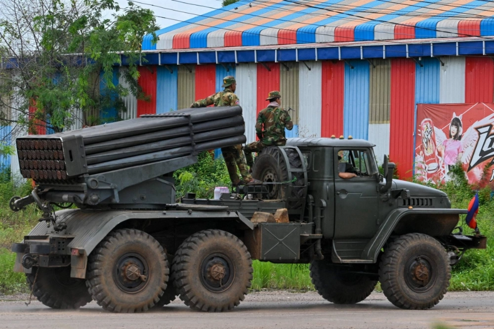 Cambodian soldiers ride in a truck equipped with a Russian-made BM-21 rocket launcher in the country's northern Oddar Meanchey province, which borders Thailand, on Sunday. Cambodian soldiers ride in a truck equipped with a Russian-made BM-21 rocket launcher in the country's northern Oddar Meanchey province, which borders Thailand, on Sunday.